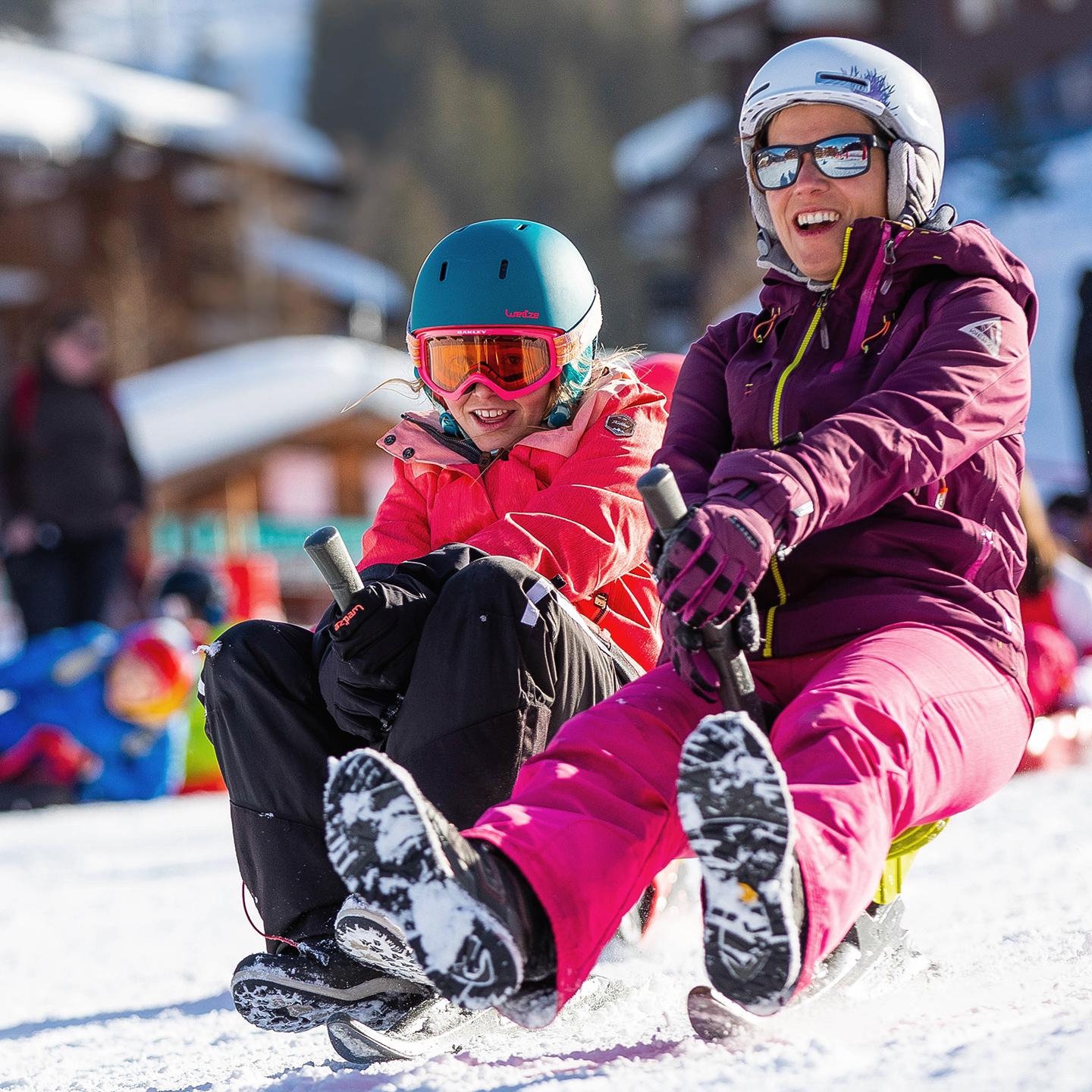 Une adulte et une enfant descende une piste du Grand Domaine à Valmorel en Savoie, destination Famille